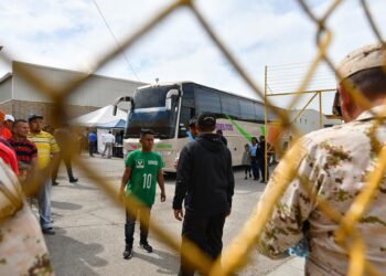 Fotografía de archivo de migrantes que esperan para subir a los autobuses que los trasladarán a las ciudades de Hermosillo. EFE/ Miguel Sierra