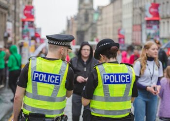 Edinburgh city police keep an eye on crowds at the Royal Mile during Edinburgh Fringe Festival.