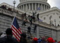 Supporters of U.S. President Donald Trump climb a wall during a protest against the certification of the 2020 presidential election results by the Congress, at the Capitol in Washington, U.S., January 6, 2021. Picture taken January 6, 2021. REUTERS/Jim Urquhart