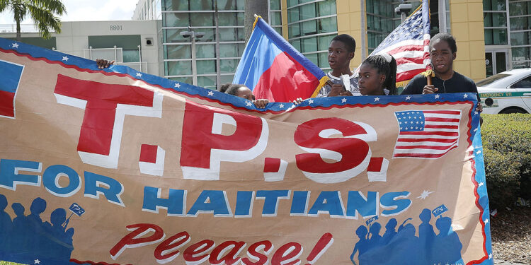 MIAMI, FL - MAY 13:  People protest the possibility that the Trump administration may overturn the Temporary Protected Status for Haitians in front of the U.S. Citizenship and Immigration Services office on May 13, 2017 in Miami, Florida.  50,000 Haitians have been eligible for TPS and now the Trump administration has until May 23 to make a decision on extending TPS for Haitians or allowing it to expire on July 22 which would mean possibly deportation for the current TPS holders.  (Photo by Joe Raedle/Getty Images)