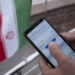 An Iranian park guard enters password on his smartphone as he tries to connect to an Irancell 5G network through the Huawei modem in northern Tehran on February 16, 2021. Irans first 5G network has ran by the Irancell company which is an Iranian telecommunications company that operates Iran's largest 2G-3G-4G-4.5G also 5G mobile network, and fixed wireless TD-LTE internet services. (Photo by Morteza Nikoubazl/NurPhoto via Getty Images)