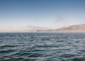 View across Pacific Ocean towards land in the distance.