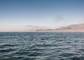 View across Pacific Ocean towards land in the distance.