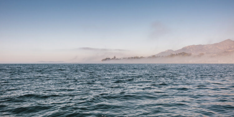 View across Pacific Ocean towards land in the distance.
