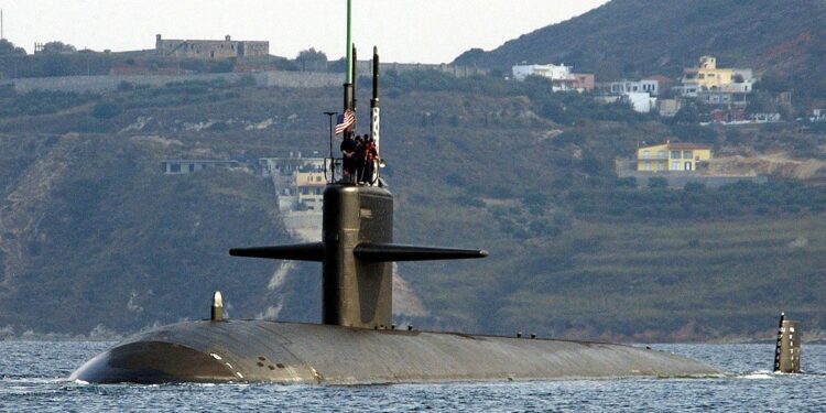 Port bow view showing US Navy (USN) Sailors manning a topside watch aboard the Los Angeles Class Attack Submarine USS NEWPORT NEWS (SSN 750), as the ship departs the harbor at Souda Bay, Crete, Greece following a port visit.