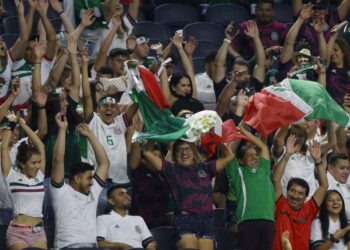 Mexico fans cheer during the first half of a CONCACAF Gold Cup Group A soccer match against Trinidad and Tobago in Arlington, Texas, Saturday, July 10, 2021. (AP Photo/Michael Ainsworth)