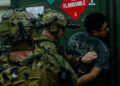 A U.S. Marine, with Maritime Raid Force, Littoral Combat Force-24, secures a role-player during a Maritime Interdiction Operation Full Mission Profile rehearsal aboard San Antonio-class amphibious transport dock USS San Antonio (LPD 17) off the coast of Venezuela, July 17, 2026. U.S. military forces are deployed to the U.S. Southern Command area of responsibility in support of Operation SOUTHERN SPEAR, Department of War-directed operations, and the president’s priorities to disrupt illicit drug trafficking, deter malign actors and protect the homeland through continuous presence. (U.S. Marine Corps photo)